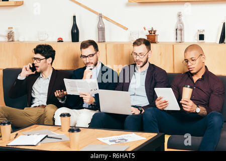 portrait of concentrated young multiracial business colleagues in cafe Stock Photo