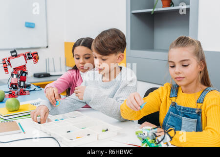 schoolchildren working on robot programming at STEM class Stock Photo