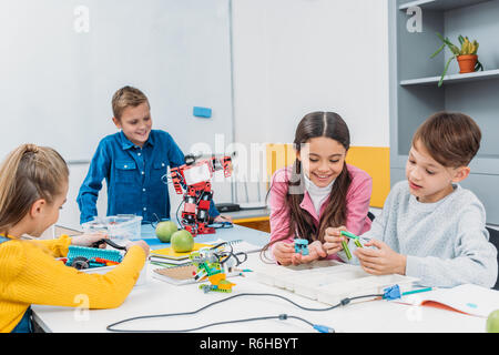 schoolkids working on robot at STEM robotics lesson Stock Photo