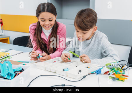 schoolchildren working on robot at STEM robotics lesson Stock Photo