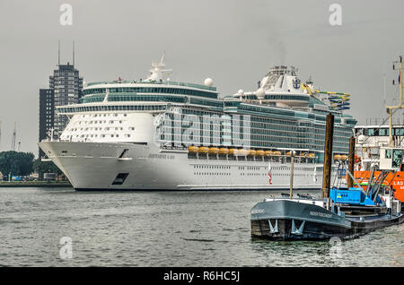 Rotterdam, The Netherlands, August 29, 2018: Cruise ship Indepence of the Seas on the river Nieuwe Maas on its way to the cruise terminal, with some o Stock Photo