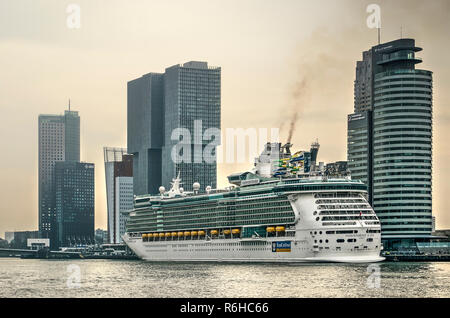 Rotterdam, The Netherlands, August 29, 2018: Cruise ship Indepence of the Seas at the cruise terminal on Wilhelmina Pier, sending black smoke into the Stock Photo