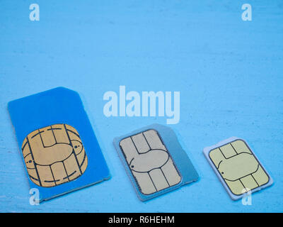 three sim cards standart, micro, nano 4g lte 5g ready on blue background. low angle shot Stock Photo