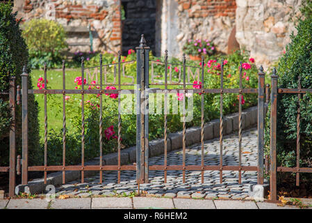 Wrought iron gate with inscription museum at the entrance to a medieval tower from the early 13th century in the city of Wiener Neustadt in Austria. Stock Photo