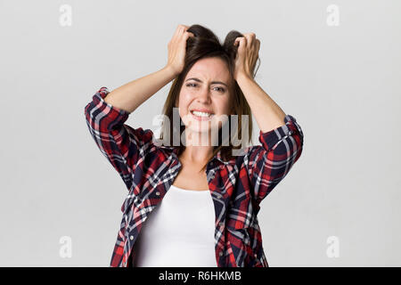 Portrait of an angry and furious female. Beautiful upset woman isolated on a white background Stock Photo