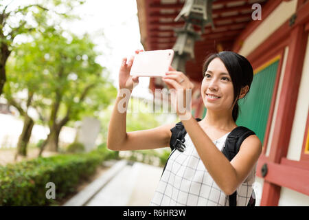 Traveler taking photo in Dazaifu Tenmangu Shrine Stock Photo