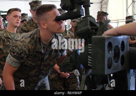 Pfc. Dylon Parker looks through the sights of an M777 155mm Howitzer during a field trip at Marine Corps Base Camp Lejeune, N.C., May 16, 2017. Marines assigned to the Marine Corps Air Station Cherry Point Squadron Intelligence Training Certification Course had the opportunity to visit various units stationed at MCB Camp Lejeune, N.C. and MCAS New River, N.C., in order to provide them a better understanding about capabilities and limitations of aircraft, weapons systems and vehicles their units may utilize. Parker is a student assigned to the MCAS Cherry Point SITCC program. Stock Photo