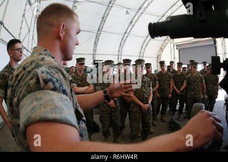 Sgt. Tyler Jackson gives a class about the M777 155mm Howitzer during a field trip at Marine Corps Base Camp Lejeune, N.C., May 16, 2017. Marines assigned to the Marine Corps Air Station Cherry Point Squadron Intelligence Training Certification Course had the opportunity to visit various units stationed at MCB Camp Lejeune, N.C. and MCAS New River, N.C., in order to provide them a better understanding about capabilities and limitations of aircraft, weapons systems and vehicles their units may utilize. Jackson is a field artillery cannoneer assigned to 2nd Battalion, 10th Marine Regiment, 2nd M Stock Photo