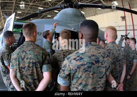 1st Lt. Robert Scoggin gives a class about the UH-1Y Venom during a field trip at Marine Corps Air Station New River, N.C., May 16, 2017. Marines assigned to the Marine Corps Air Station Cherry Point Squadron Intelligence Training Certification Course had the opportunity to visit various units stationed at MCB Camp Lejeune, N.C. and MCAS New River, N.C., in order to provide them a better understanding about capabilities and limitations of aircraft, weapons systems and vehicles their units may utilize. Scoggin is a pilot assigned to Marine Light Attack Helicopter Squadron 269, Marine Aircraft G Stock Photo