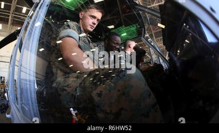 Lance Cpl. Mitch Gautreaux (left), Lance Cpl. Jeremiah Eaton explore the cockpit of a UH-1Y Venom during a field trip at Marine Corps Air Station New River, N.C., May 16, 2017. Marines assigned to the Marine Corps Air Station Cherry Point Squadron Intelligence Training Certification Course had the opportunity to visit various units stationed at MCB Camp Lejeune, N.C. and MCAS New River, N.C., in order to provide them a better understanding about capabilities and limitations of aircraft, weapons systems and vehicles their units may utilize. Gautreaux and Eaton are students assigned to the MCAS  Stock Photo