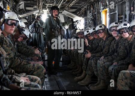 A group of Marines ride in a CH-53E Super Stallion after a field trip at Marine Corps Air Station New River, N.C., May 16, 2017. Marines assigned to the Marine Corps Air Station Cherry Point Squadron Intelligence Training Certification Course had the opportunity to visit various units stationed at MCB Camp Lejeune, N.C. and MCAS New River, N.C., in order to provide them a better understanding about capabilities and limitations of aircraft, weapons systems and vehicles their units may utilize. Stock Photo