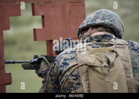 A U.S. Marine fires an SA80 A2 L85 Assault Rifle at Altcar Training ...