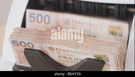 Counting dollars with electronic money counter machine Stock Photo