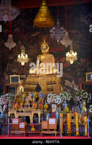 Golden Buddha statue inside one of the Ordination Hall's Buddhist temples in Bangkok, Thailand. Stock Photo