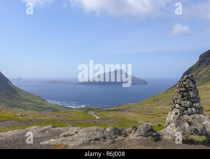 Looking south west towards the small uninhabited island of Koltur, taken from Nordradalsvegur on the main island of Faroe Stock Photo