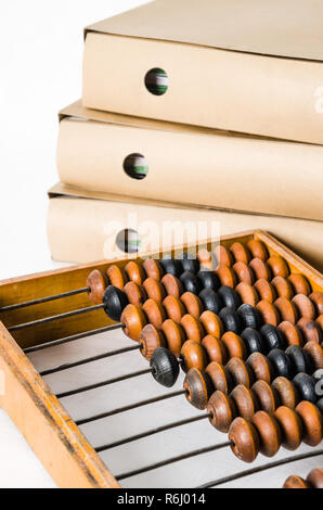 Old abacus and folders with documents, close-up Stock Photo