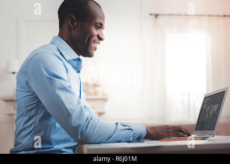 Handsome cheerful man working Stock Photo
