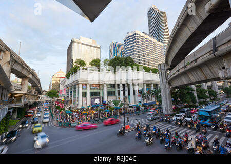 High angle shot of Ratchaprasong Intersection and Erawan Shrine in Bangkok, Thailand, with motion blurred cars driving past in busy traffic. Stock Photo