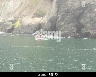 San Francisco Fire Department members aboard a jet ski assist a distressed swimmer near China Beach, May 20, 2017, Saturday. Coast Guard Station Golden Gate and San Francisco Fire Department rescued 2 hypothermic swimmers. (Coast Guard Stock Photo