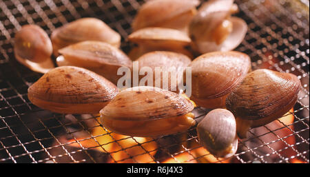 Fresh clams on barbecue fire Stock Photo