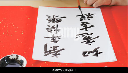 Writing of Chinese new year calligraphy, phrase meaning is blessing for  good health Stock Photo - Alamy