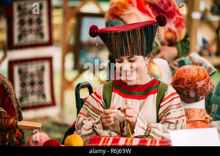 Vetka, Belarus - June 23, 2018: Woman In Ethnic Traditional Folks National Russian Costume Dress Weaving Belt Stock Photo