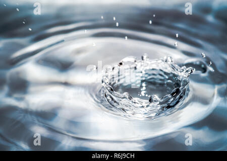 Drop or water in different colors and shapes, created a beautiful shape after hitting a water surface. Captured through high speed photography Stock Photo