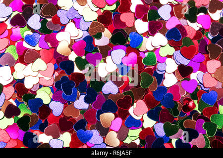 many small decorative hearts of different colors, background image Stock Photo