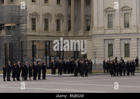 December 5, 2018 - Washington, District of Columbia, United States - Family members and senior members of Congress stand in honor of George Herbert Walker Bush, 41st President of the United States, as his casket leaves the Capitol Building to go to his State Funeral. December 5, 2018.Family members in the group on the left, from left to right: COLUMBA BUSH, wife of JEB BUSH, JOHN ELLIS ''JEB'' BUSH, former Governor of Florida and Presidential Candidate, DOROTHY 'DORA'' WALKER BUSH KOCH, BOBBY KOCH, husband of DORA KOCH, MARIA ANDREWS (holding hands with NEIL MALLON BUSH), wife of NEIL MALL Stock Photo