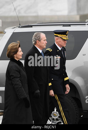 (181205) -- WASHINGTON, Dec. 5, 2018 (Xinhua) -- Former U.S. President George W. Bush (C) and his wife Laura Bush (L) are seen outside the U.S. Capitol before the casket of former U.S. President George H.W. Bush is transported to the National Cathedral for a state funeral in Washington, DC, the United States, on Dec. 5, 2018. In laughter and tears, the United States held a state funeral here Wednesday for the 41st President George H.W. Bush, who has been widely mourned and praised as a good leader and a devoted person with a 'gentle soul' and great sense of humor during his 94-year-long lifet Stock Photo