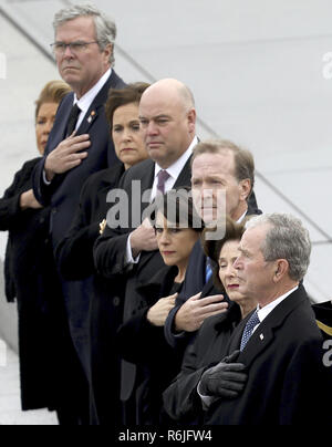 Washington, DC, USA. 5th Dec, 2018. Former U.S. President George W. Bush, right, his wife Laura Bush, second from right, and brother Jeb Bush, second from left, watch as a U.S. military honor guard carries the flag-draped casket of former President George H.W. Bush from the U.S. Capitol Wednesday, Dec. 5, 2018, in Washington. (Win McNamee/Pool Photo via AP) Credit: Win Mcnamee/CNP/ZUMA Wire/Alamy Live News Stock Photo