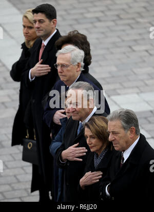 Congressional leaders (L-R) Speaker of the House Paul Ryan (R-WI), Senate Majority Leader Mitch McConnell (R-KY), Senate Minority Leader Chuck Schumer (D-NY) and House Minority Leader Nancy Pelosi (D-CA) watch as a U.S. military honor guard team carries the flag draped casket of former U.S. President George H. W. Bush from the U.S. Capitol December 5, 2018 in Washington, DC. A funeral service will be held today for former U.S. President Bush at the Washington National Cathedral. President Bush will be buried at his final resting place at the George H.W. Bush Presidential Library at Texas A&M U Stock Photo