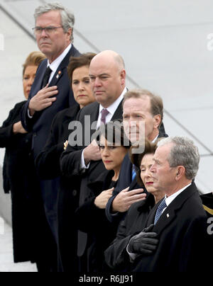 Former U.S. President George W. Bush, right, his wife Laura Bush, second from right, and brother Jeb Bush, second from left, watch as a U.S. military honor guard carries the flag-draped casket of former President George H.W. Bush from the U.S. Capitol Wednesday, Dec. 5, 2018, in Washington.  Credit: Win McNamee / Pool via CNP | usage worldwide Stock Photo