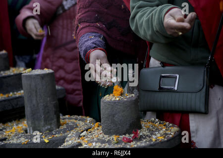 Kathmandu, Nepal. 6th Dec, 2018. Nepalese devotees walk at the premises of Pashupatinath temple offering seeds in memory of deceased family members during Bala Chaturdashi festival.Bala Chaturdashi is celebrated in memory of departed family members by lighting oil lamps and scattering seven types of seeds known as ''SATSIJ'' along a prescribed route. Credit: Sunil Pradhan/SOPA Images/ZUMA Wire/Alamy Live News Stock Photo