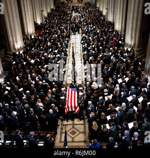 The Honor Guard carries the casket of former president George Herbert Walker Bush down the center isle following a memorial ceremony at the National Cathedral in Washington, Wednesday,  Dec.. 5, 2018.   Credit: Doug Mills / Pool via CNP / MediaPunch Stock Photo