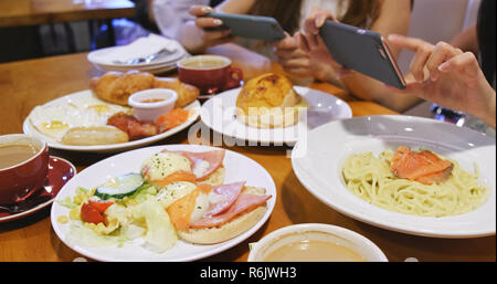 Women taking photo on English breakfast Stock Photo