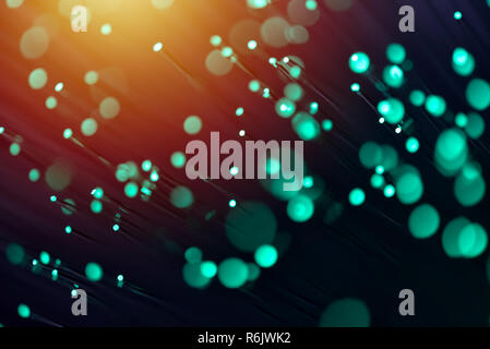 Fiber optics in green, close up with bokeh, warm lens flare Stock Photo