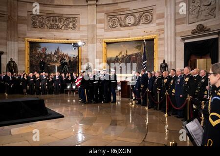 A U.S. joint service honor guard carries the flagged draped casket of former President George H.W. Bush to lie in state at the U.S. Capitol Rotunda December 3, 2018 in Washington, DC. Bush, the 41st President, died in his Houston home at age 94. Stock Photo