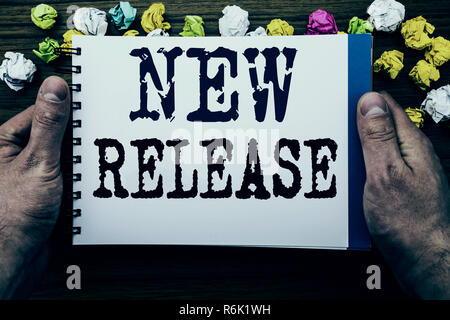 Writing text showing New Release . Business concept for Technology Software Update written on notepad notebook book on the wooden wood background with man businessman hand and finger. Stock Photo