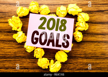 Word, writing 2018 Goals. Business concept for New Yer resolutions written on sticky note paper on the wooden background. Stock Photo