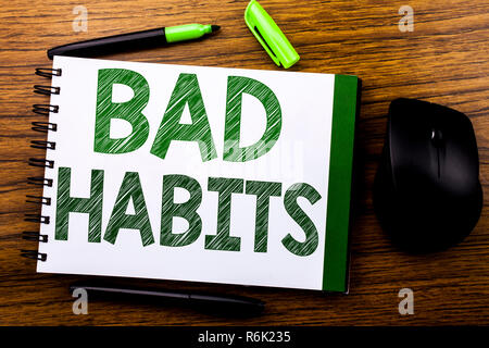 Handwriting Announcement text showing Bad Habits. Business concept for Improvement Break Habitual Hebit written on notebook book note paper on the wooden background. Green word letters. Next to mouse. Stock Photo
