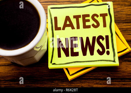 Handwritten text showing Latest News. Business concept for Fresh Current New Story written on sticky note paper on the wooden wood background with coffee cup Stock Photo