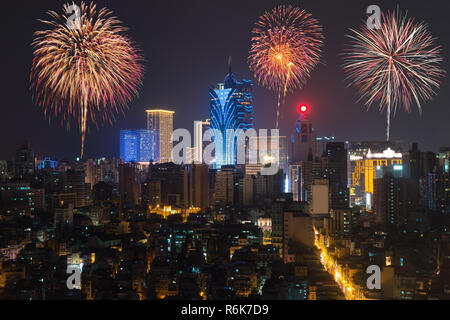 New Yearâ€™s fireworks at Macau (Macao), China. Skyscraper hotel and casino building at downtown in Macau (Macao). Stock Photo