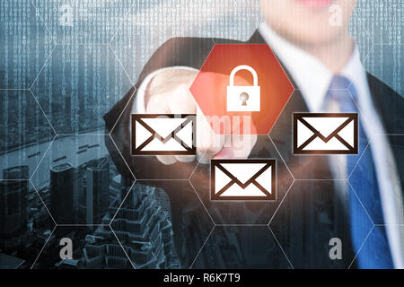 Businessman pressing e-mail security button on virtual screens for internet and e-mail security. Business, technology, internet and virtual reality co Stock Photo
