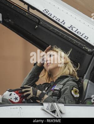 Miss Oklahoma 2016, Sarah Klein, adjusts her hair after doffing her helmet before getting out of the  in the backseat of a Thunderbirds F-16D May 18, 2017, Tinker Air Force Base, Oklahoma. Klein was flown by Lt Col. Kevin Walsh, Thunderbirds operations officer, during an orientation flight in which she pulled 9.2 Gs. Stock Photo