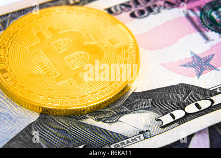 Golden bitcoin coin on US dollar banknote Stock Photo