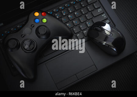 https://l450v.alamy.com/450v/r6kbe4/gamepad-and-mouse-on-pc-keyboard-on-black-background-video-game-controllers-joystick-vs-keyboard-top-view-background-r6kbe4.jpg