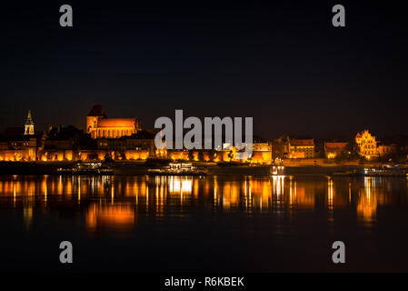 Panorama of medieval city center in Torun. Teutonic castle with brick wall around it. Gothic architecture in european town Stock Photo