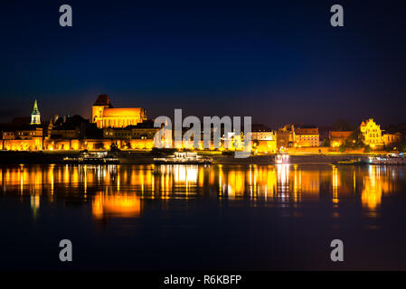 Ancient city Torun at night. Panorama of old town from Vistula river Stock Photo