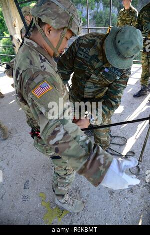 Greek paratroopers with 1st Paratrooper Commando Brigade, Greek Army conduct rappelling training for Sky Soldiers from B Company, 1st Battalion, 503rd Infantry Regiment, 173rd Airborne Brigade, May 20, 2017 in Camp Rentina, Greece as a part of Exercise Bayonet Minotaur 2017. Bayonet-Minotaur is a bilateral training exercise between U.S. Soldiers assigned to 173rd Airborne Brigade and the Greek Armed Forces, focused on enhancing NATO operational standards and developing individual technical skills. Stock Photo